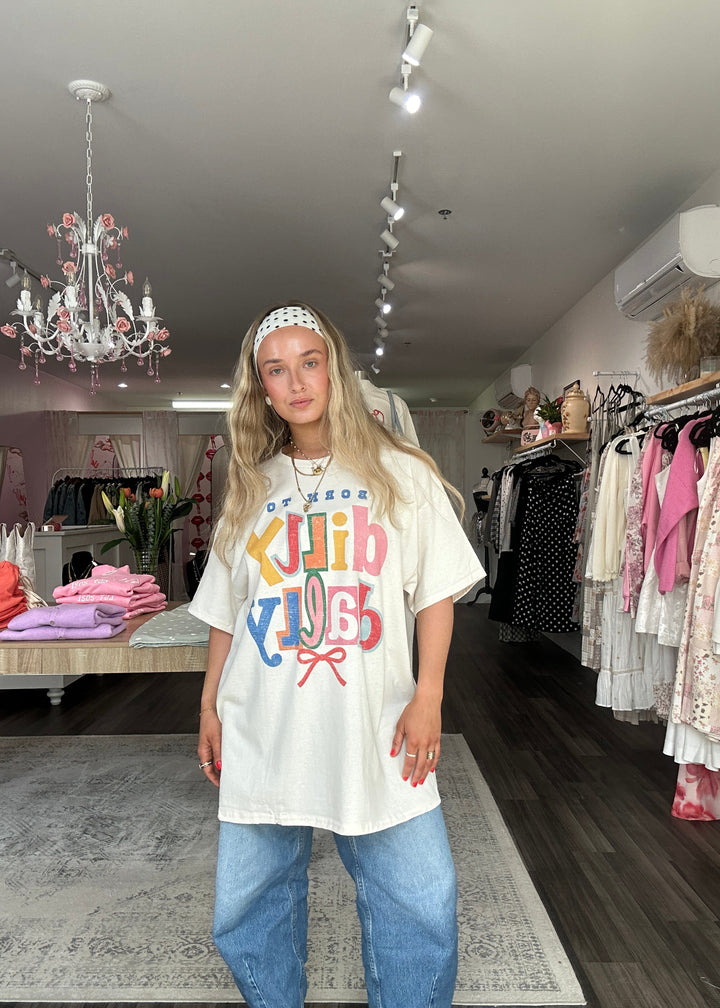 Woman wearing a colorful t-shirt with text in a store setting