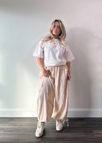 drawstring cotton pants with scrunchy texture, adjustable bottoms, and side pockets