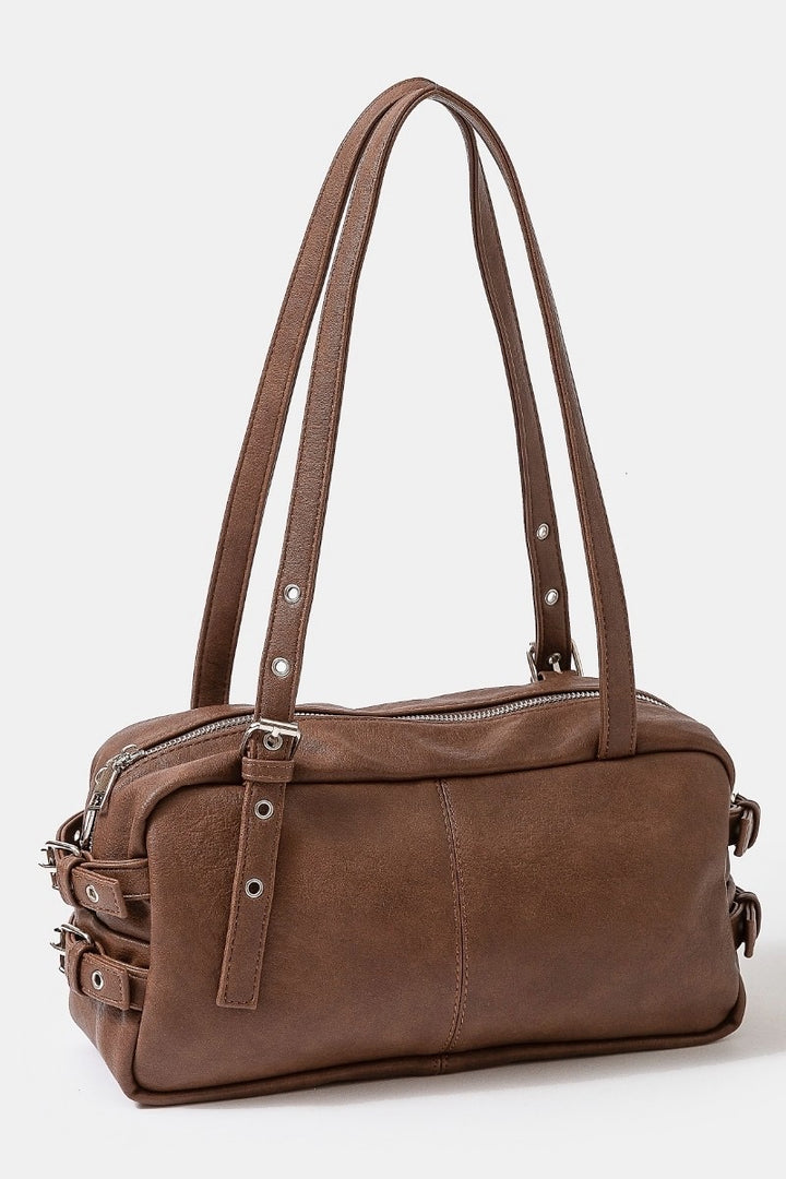Brown leather handbag with multiple straps on a white background