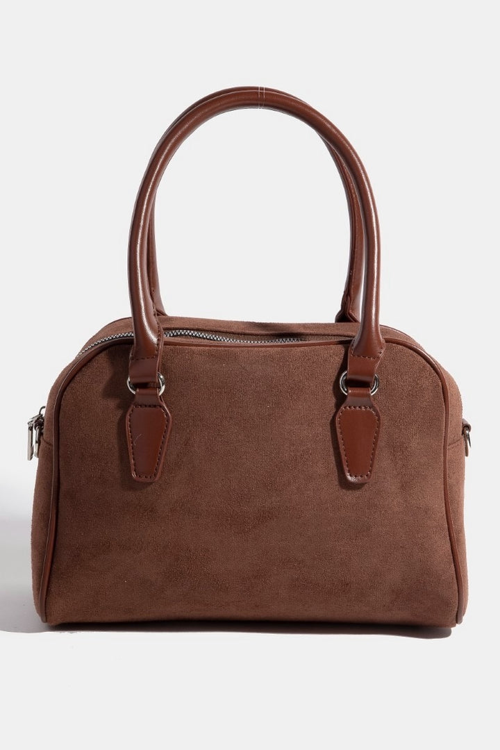 Brown handbag with leather handles and trim on a white background