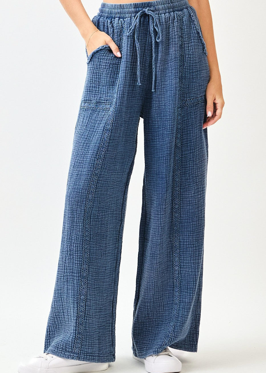 Blue checkered pants worn by a person on a white background